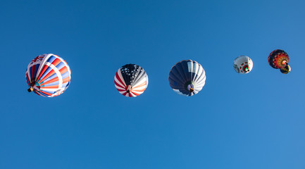 Hot air balloons up and away in the straight line