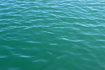 Fototapeta na wymiar Blue green sea water surface texture ripples background