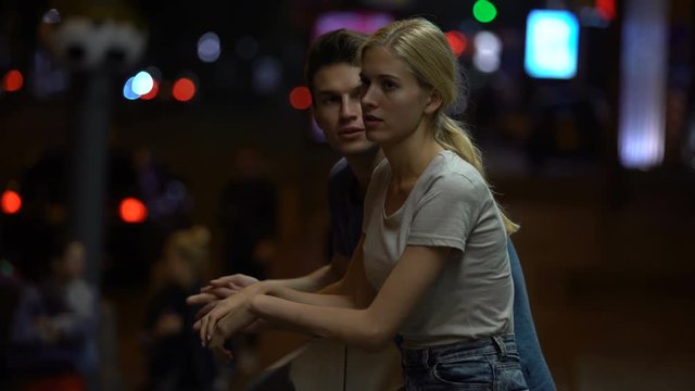 Young couple arguing and braking down relationship, night street background