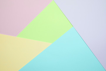 Fashionable  pastel colored paper flat lay top view, geometric background texture, pink, purple, yellow, beige, green and blue.