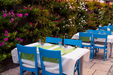 A cozy cafe on the terrace in the restaurant, overlooking the sea and tropical plants. Service for holidays and weekends. Vacation at the sea and dinner at the restaurant.