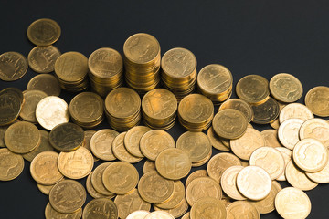 Savings, increasing columns of coins, piles of coins arranged as a graph in dark room, business banking concept.