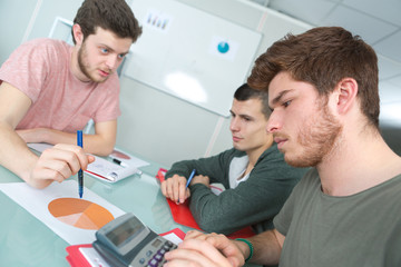 Fototapeta na wymiar three students communicating in classroom