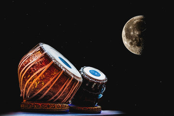 ethnic musical instrument tabla on the night sky background - obrazy, fototapety, plakaty