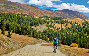 Bicyclist riding up Boreas Pass Road near Breckenridge, Colorado