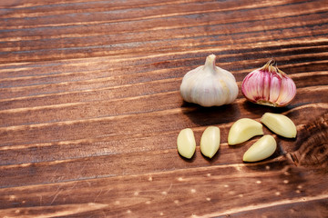 close up on garlic over dark wood, space for text