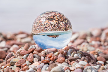 Sveti Stefan old town reflected in glass ball