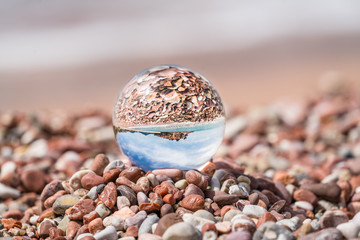 Sveti Stefan old town reflected in glass ball