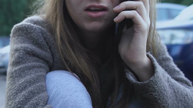 Frightened girl calling emergency, injured after road accident, state of shock