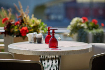 Colored glasses on the table in a summer cafe