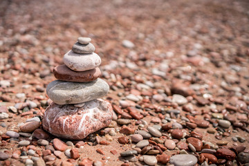 Fototapeta na wymiar Pile of stacked stones on the beach