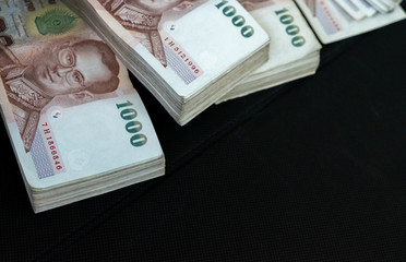 selective focus. many of  Thai banknote on black background, thai money on black background