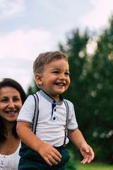 portrait of a boy and mother in park