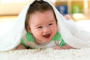 Happy baby boy lying down and resting