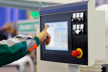 operator prepares equipment with CNC for new task