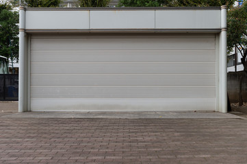 A closeup shot of automatic metal roller door used in factory, storage, garage, and industrial...