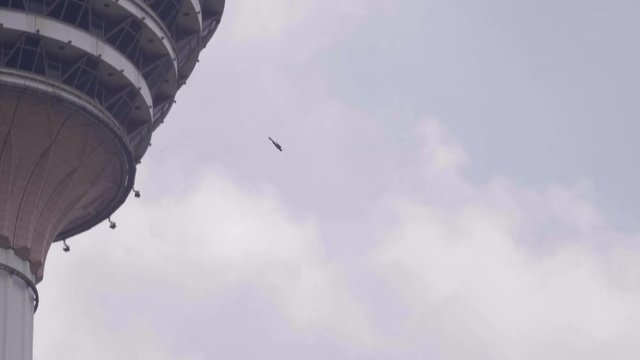 Base jumpers jumping from Menara tower in Kuala Lumpur.