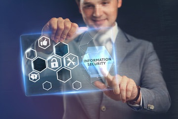 Business, Technology, Internet and network concept. Young businessman working on a virtual screen of the future and sees the inscription: Information security .