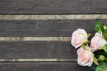 pink roses on the old wooden table
