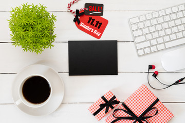 Online shopping of China, 11.11 single day sale concept. Red and black ticket with coffee cup, keyboard computer and mouse on white wooden background. Shopping concept.