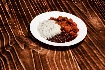 Rice, beans, and soy meat on wooden board