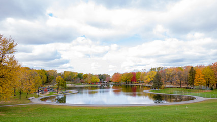 Beaver lake at the top of Mont-Royal, as foliage bursts with autumn colors. Montreal, Canada