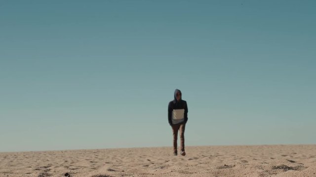 Man walking alone in the sunny desert near Dubai backpack tourist alone