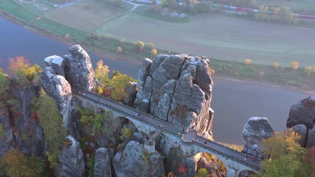 Bridge Crossing an Incredible Rock Formation Above a River Valley at Sunset