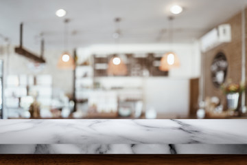 Empty marble table with blur cafe background.