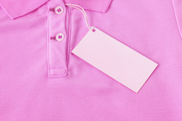 Blank tag label on pink shirt background.