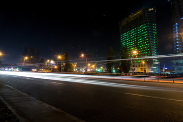 Fototapeta na wymiar Kyiv night car trails on the modern building background, ukraine
