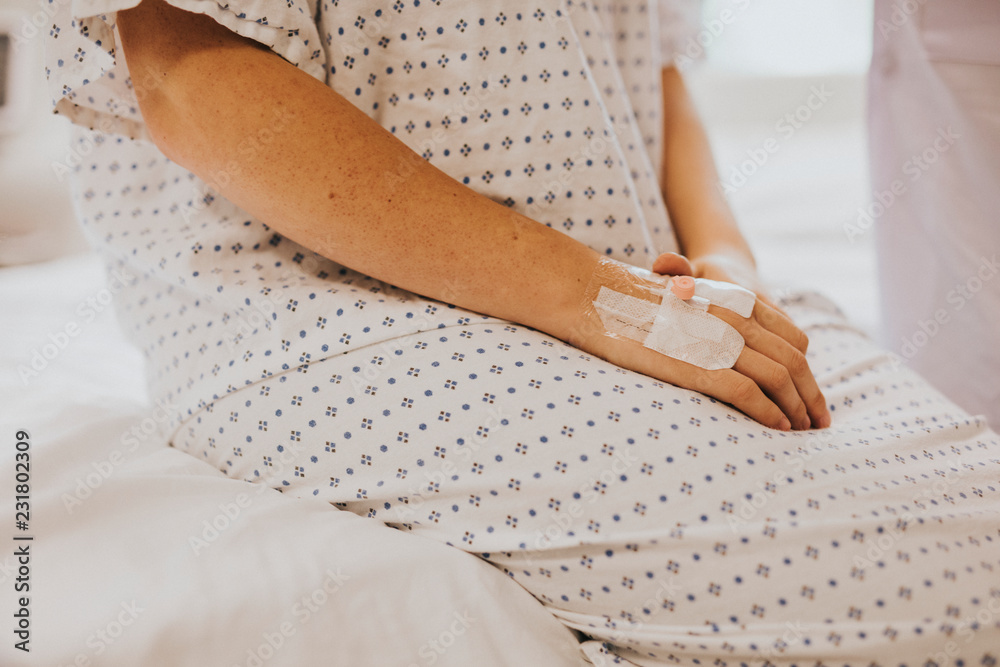 Wall mural woman sitting on her hospital bed