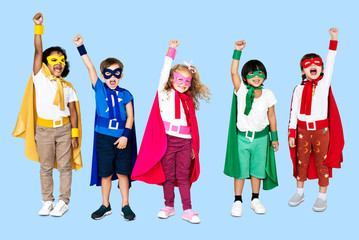 Cheerful kids wearing superhero costumes