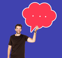 Cheerful man holding a blank speech bubble symbol