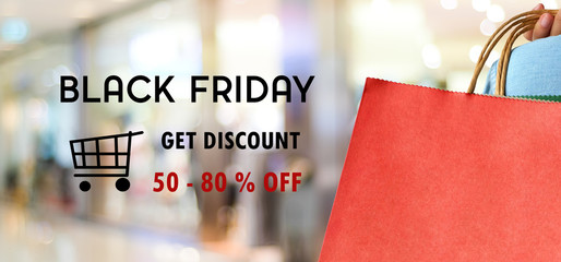 Black friday sale on red shopping bag and blur store background, online shopping banner background, web banner, shopping on line promotion, digital marketing, business concept