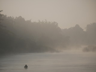 Fisherman with small boat, Fog over the YOM river.Shooting location is Sukhothai Thailand. 