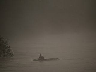 Fototapeta na wymiar Fisherman with small boat, Fog over the YOM river.Shooting location is Sukhothai Thailand. 