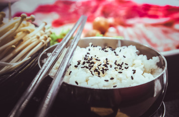 rice and black sesame seeds with chopsticks, Set of slice raw pork ,chicken and vegetable to grill.