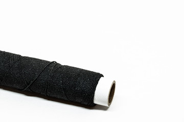 Black cotton thread isolated on white background.