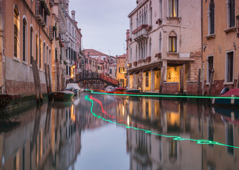 View on small canal in venice with passing by boat