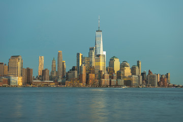 Fototapeta na wymiar New York City skyscrapers at sunset and Hudson River from Hoboken promenade.