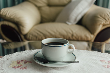 Coffee cup on table in moody atmosphere.