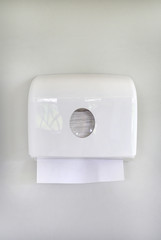 White box of tissues on wall in toilet