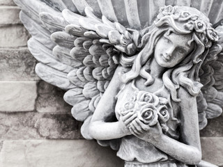 Fairy statue decorated on the stone texture wall