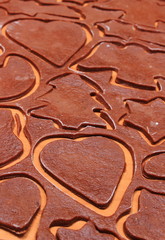 Dough for gingerbread in shape of heart, star and christmas tree