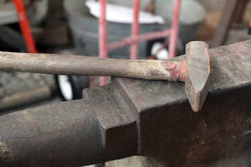 Blacksmith anvil and hammer in workshop