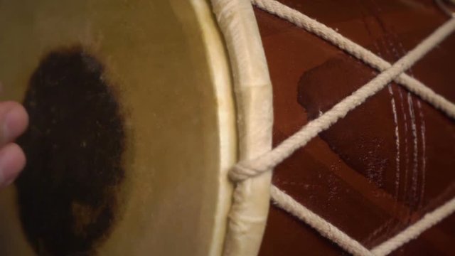Close up of hands of a man playing a drum. Slow Motion.
