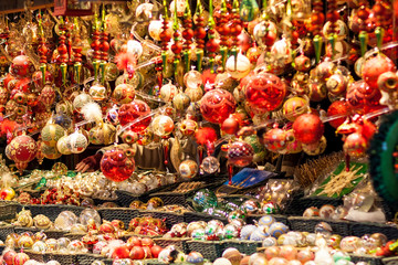 Fototapeta premium Red and golden christmas tree ornaments and balls, advent market stall close up, photo
