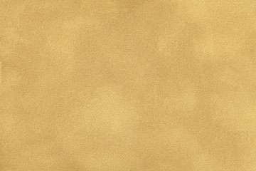 Ocher matt suede fabric closeup. Velvet texture.