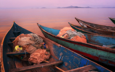 Colorful scenic sunset with fishing boats in the foreground on Mfangano Island, Lake Victoria, Kenya